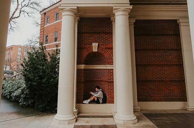 person sitting in a brick inset of Weatherford Hall